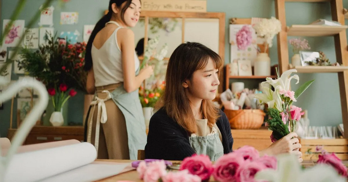 Florist arranging a fresh bouquet in a flower shop, the kind of local shop SEO for florists helps buyers find.