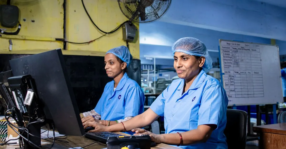 Manufacturing staff working at computers on the factory floor, the kind of operation a manufacturer website turns into quote requests.