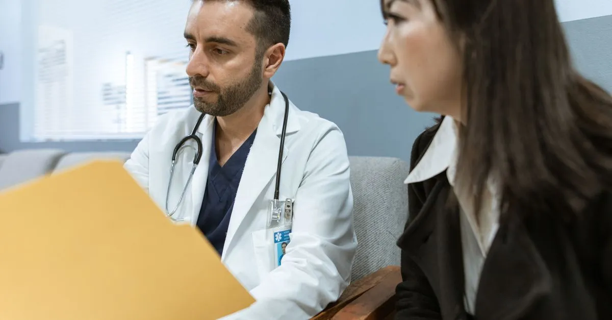 A doctor discussing treatment options with a patient in a clinic, the kind of practice healthcare SEO services help patients find.