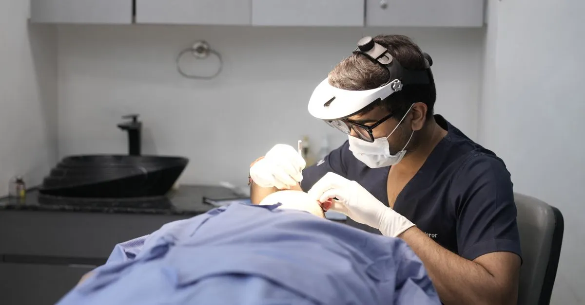 A board-certified dermatologist examining a patient's skin in a clinic, the kind of practice local SEO for dermatologists helps patients find.