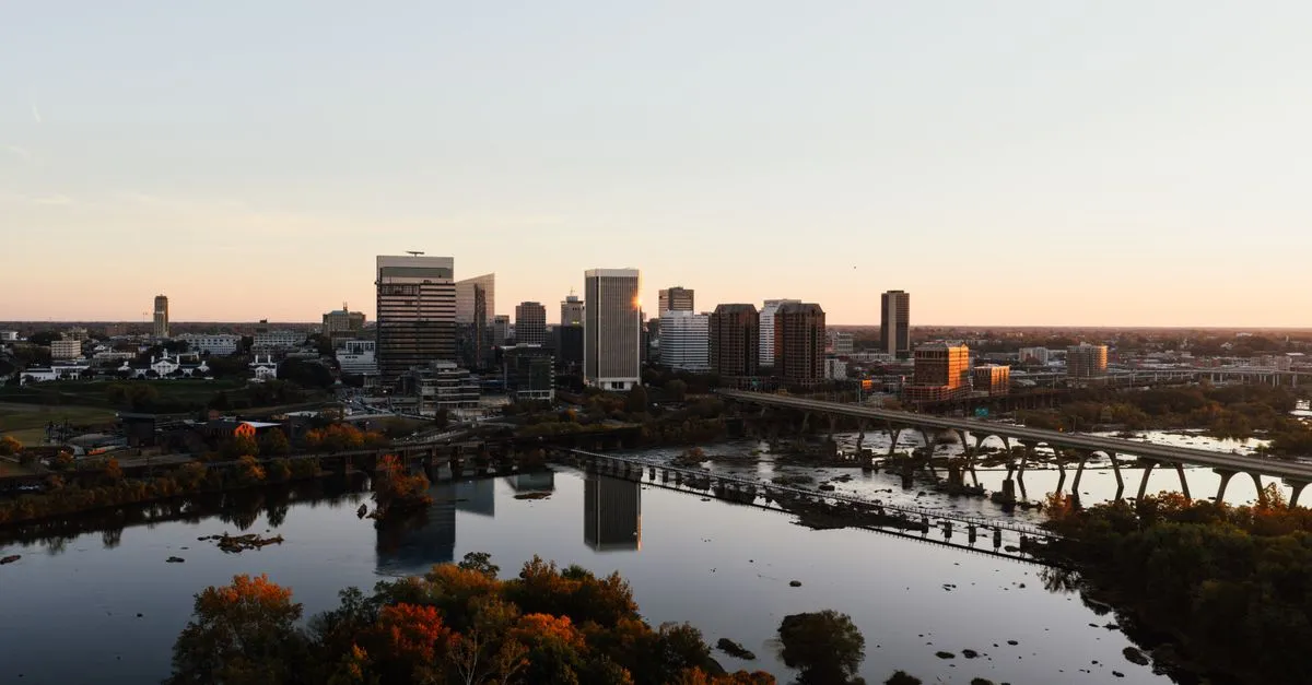 The Richmond, Virginia skyline at sunset above the James River and its pedestrian bridge, where local businesses compete for attention online.