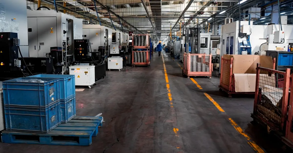 A busy manufacturing floor with machinery and crates, the kind of shop manufacturing SEO helps buyers find.