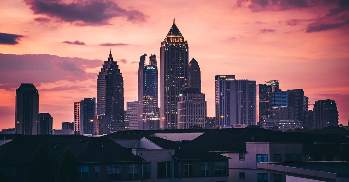 The Atlanta skyline at sunset, with high-rise office towers where local businesses compete for attention online.