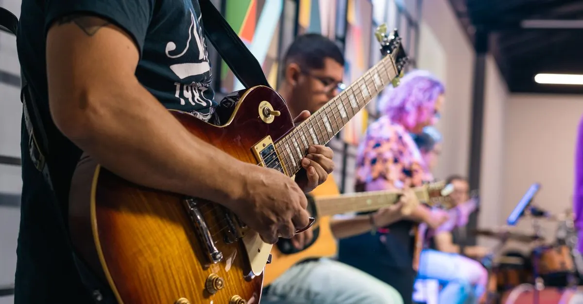 A guitarist performing live to a crowd, the kind of show a musician website puts front and center.