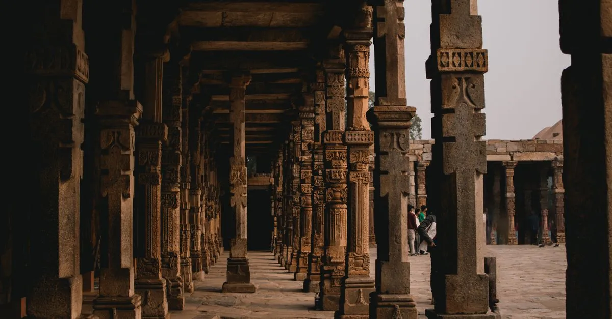 Rows of carved stone pillars in a historic corridor, standing in for a pillar page that supports a whole topic.