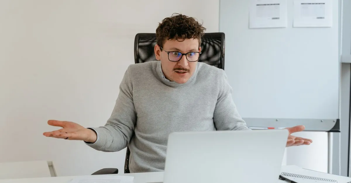 A person looking puzzled at a laptop, wondering why their business is not on Google.