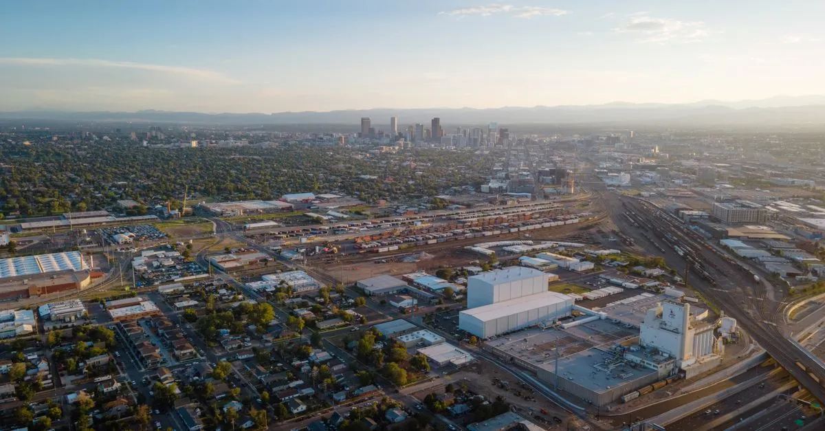 Aerial view of the Denver skyline spreading toward the Front Range, the growing metro where the local map pack is won.