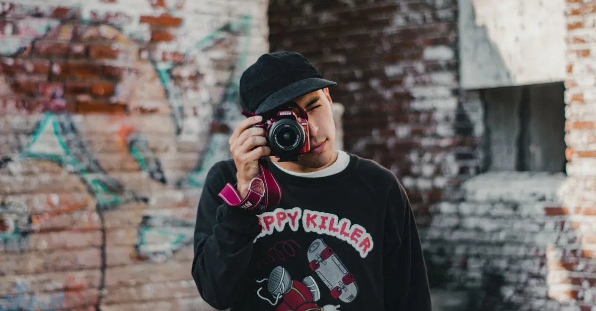 A young photographer shooting with a DSLR, the kind of pro that SEO for photographers helps clients find in search.