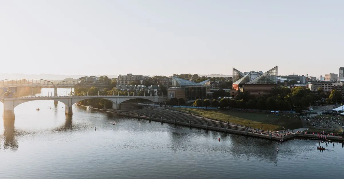 The Chattanooga, Tennessee riverfront at sunset, with the Tennessee River, the pedestrian bridge, and downtown landmarks where local businesses compete for attention online.