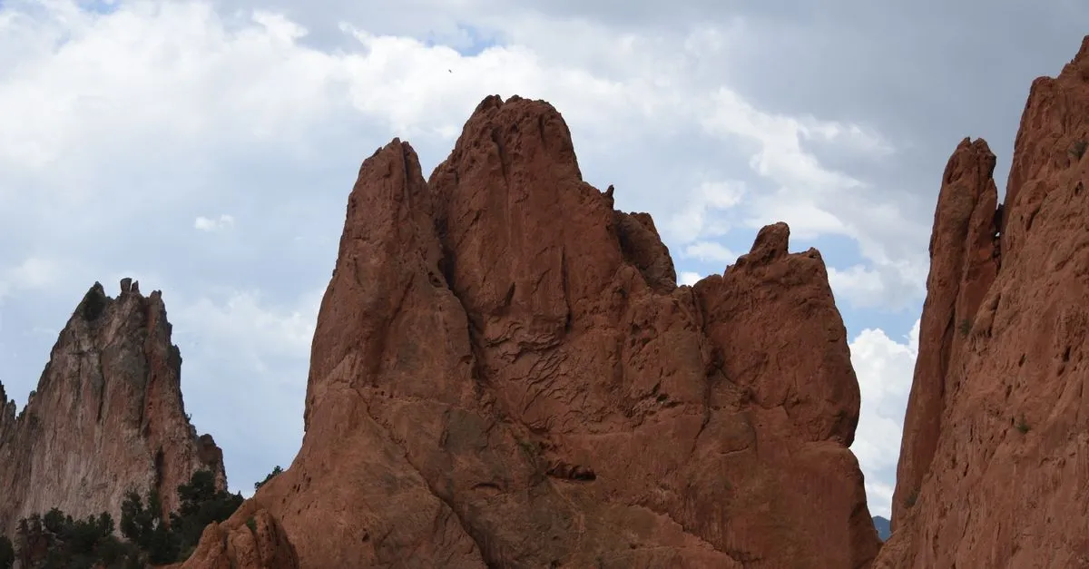 The red rock spires of Garden of the Gods rising under a cloudy sky in Colorado Springs, the local market where the map pack is won.
