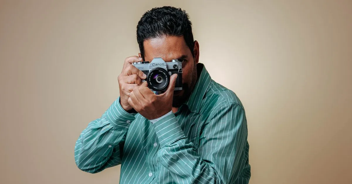 A photographer holding a camera, the kind of pro a website builder for photographers is built to showcase.