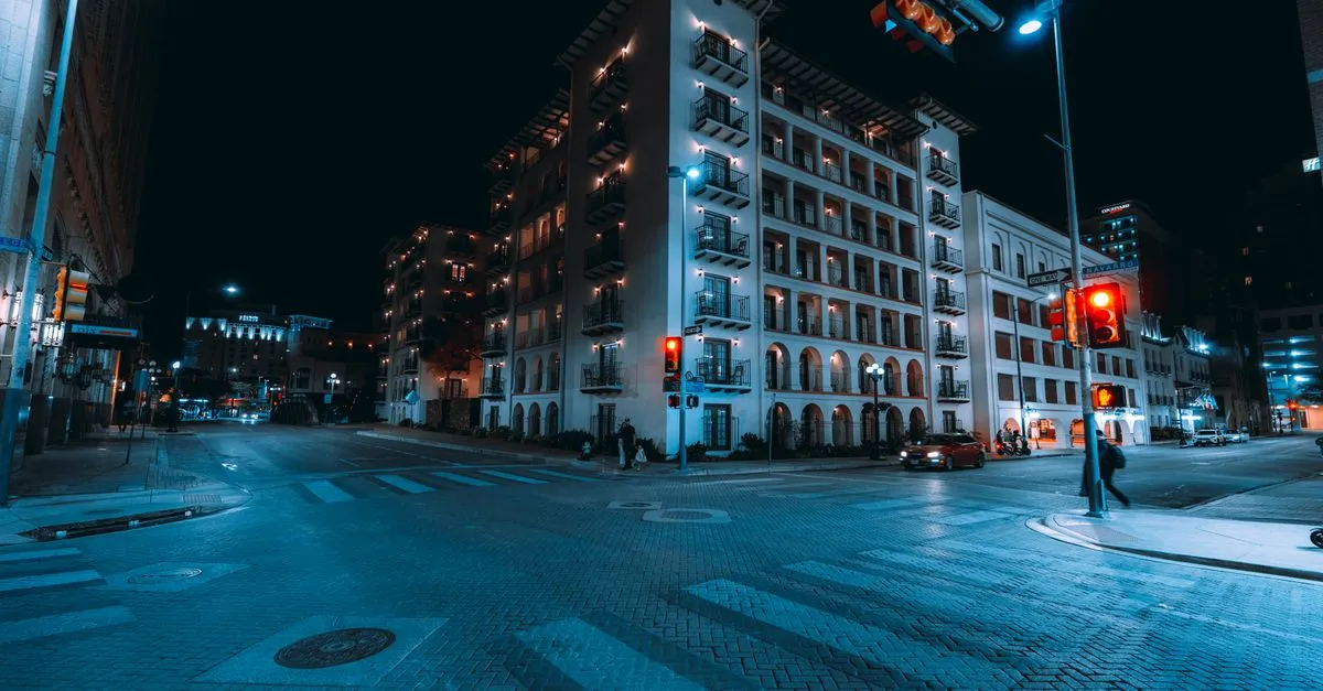 A vibrant nighttime street scene in downtown San Antonio, Texas, the busy local market a San Antonio SEO strategy has to reach.