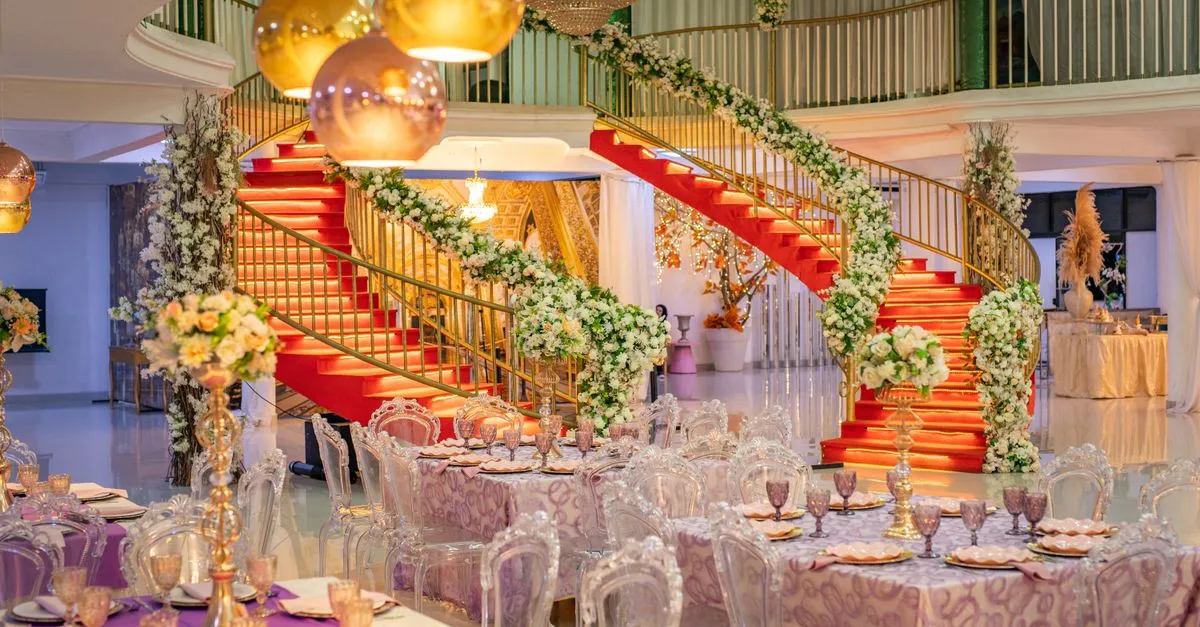 An elegant wedding venue reception hall with floral decor and set tables, the kind of space SEO for wedding venues helps couples find.