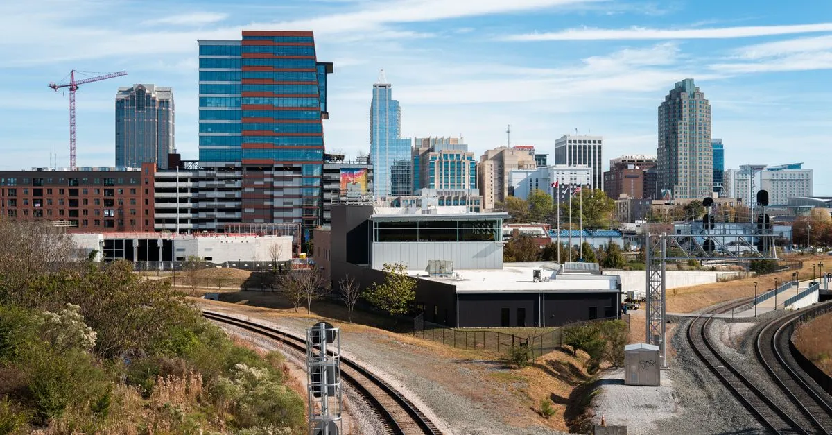 The downtown Raleigh skyline above the rail lines, the Research Triangle market where the local map pack is won.