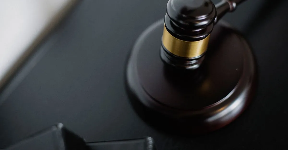 A wooden gavel resting on a desk beside case folders in a law office, the kind of firm clients find when they search for a lawyer near me.