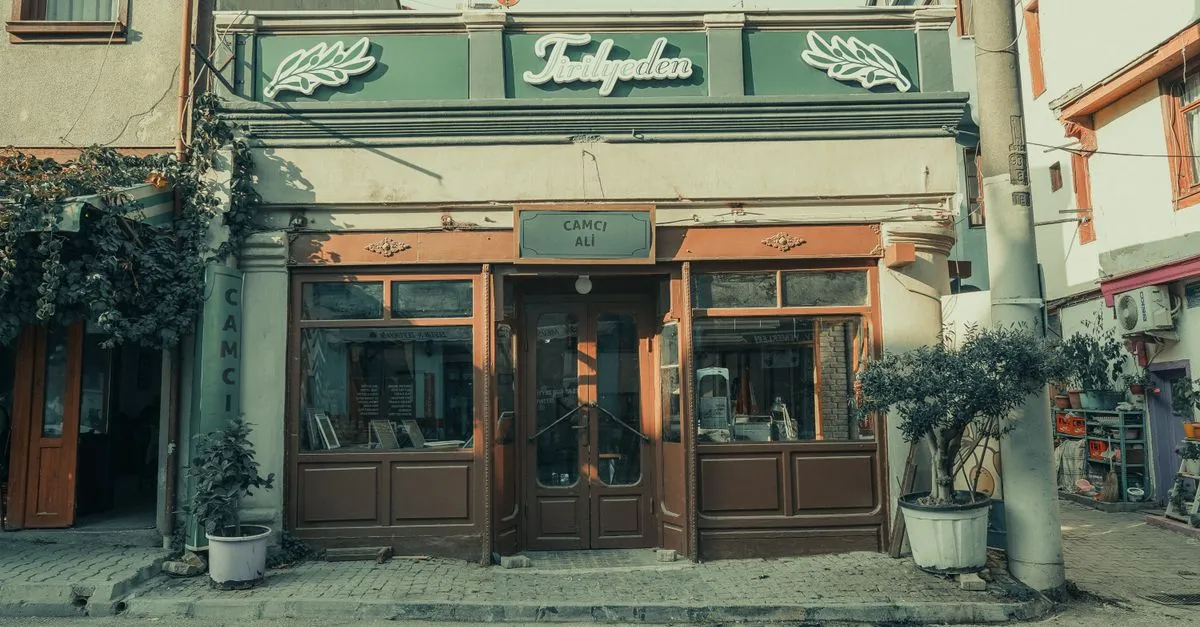A small shopfront with its name painted above the door on a quiet street, the kind of local business that lives or dies by accurate online listings.