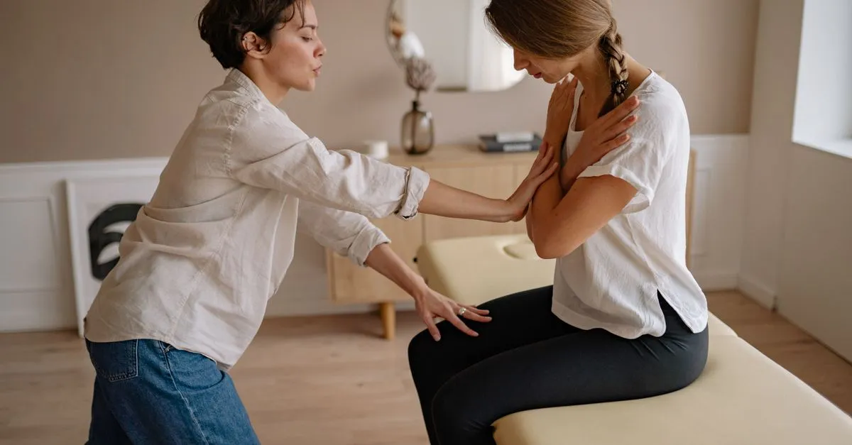 A chiropractor working with a patient on a treatment table in a clinic, the kind of practice website design for chiropractors is built to fill.