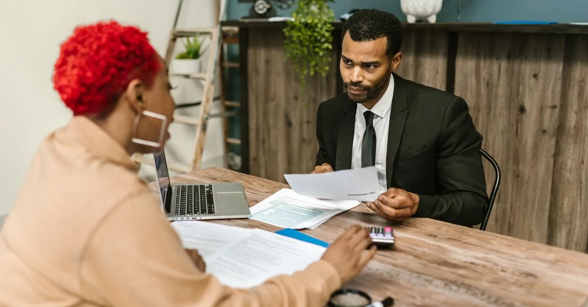A person meeting with a banker at a member-owned credit union to review loan rates, the kind of branch SEO for credit unions helps get found.