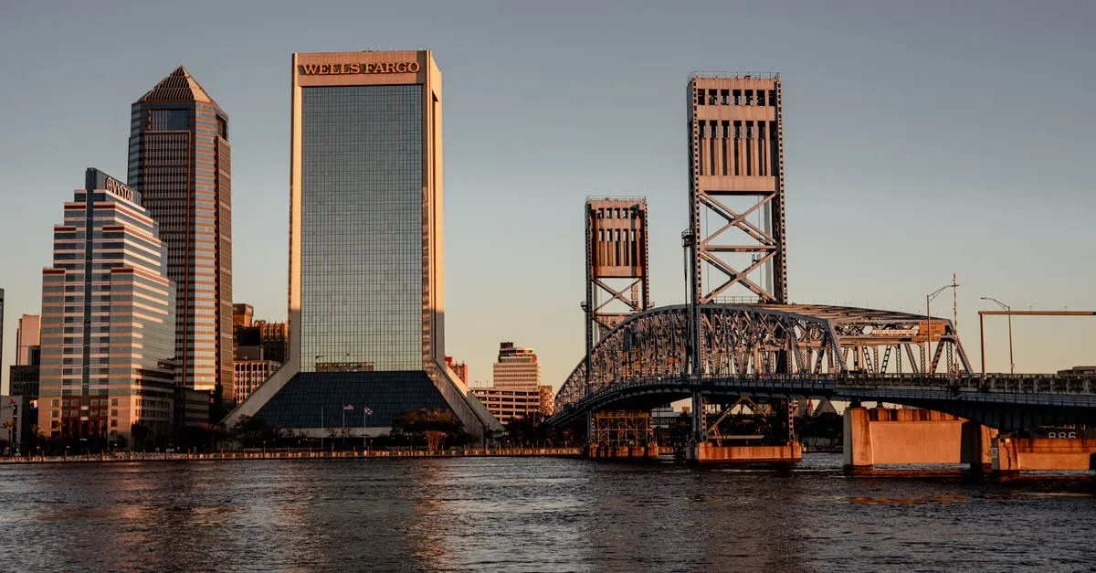 The downtown Jacksonville, Florida skyline at sunset with the Main Street Bridge crossing the St. Johns River.
