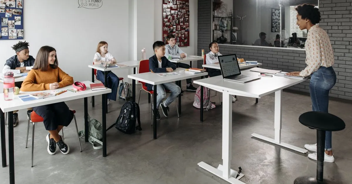 Students listening to a teacher in a modern classroom, the kind of school families find through education SEO.