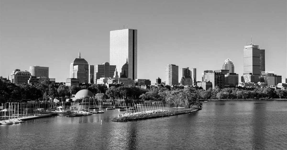 The Boston skyline and Back Bay towers seen across the Charles River, the dense walkable market where the map pack is won.