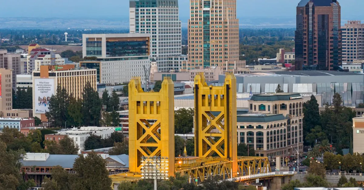 The gold Tower Bridge and the downtown Sacramento skyline at dusk, the growing capital market where the local map pack is won.