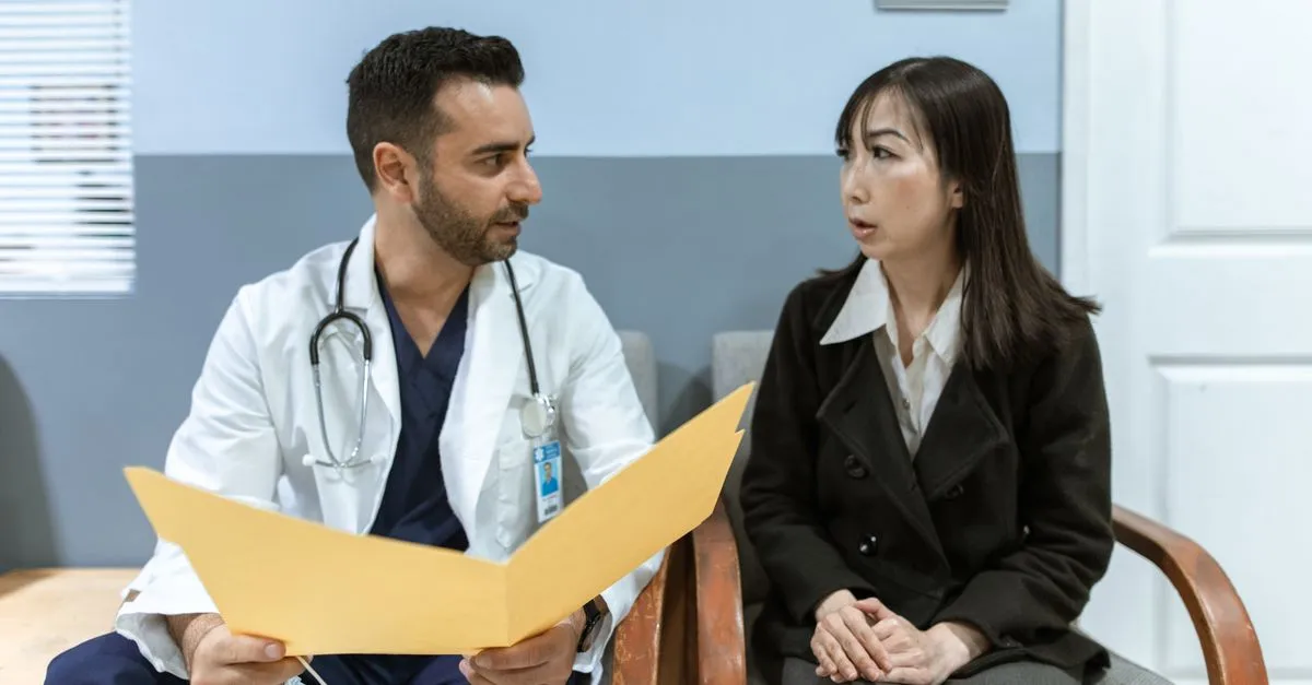 A plastic surgeon talking a patient through a procedure during a consultation, the kind of practice SEO for plastic surgeons helps patients research and find.