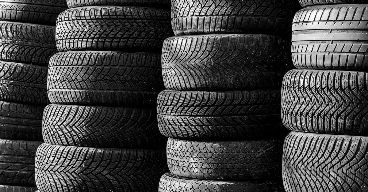 Stacked vehicle tires showing various tread patterns, the kind of inventory a local tire shop sells when drivers search for tires near me.