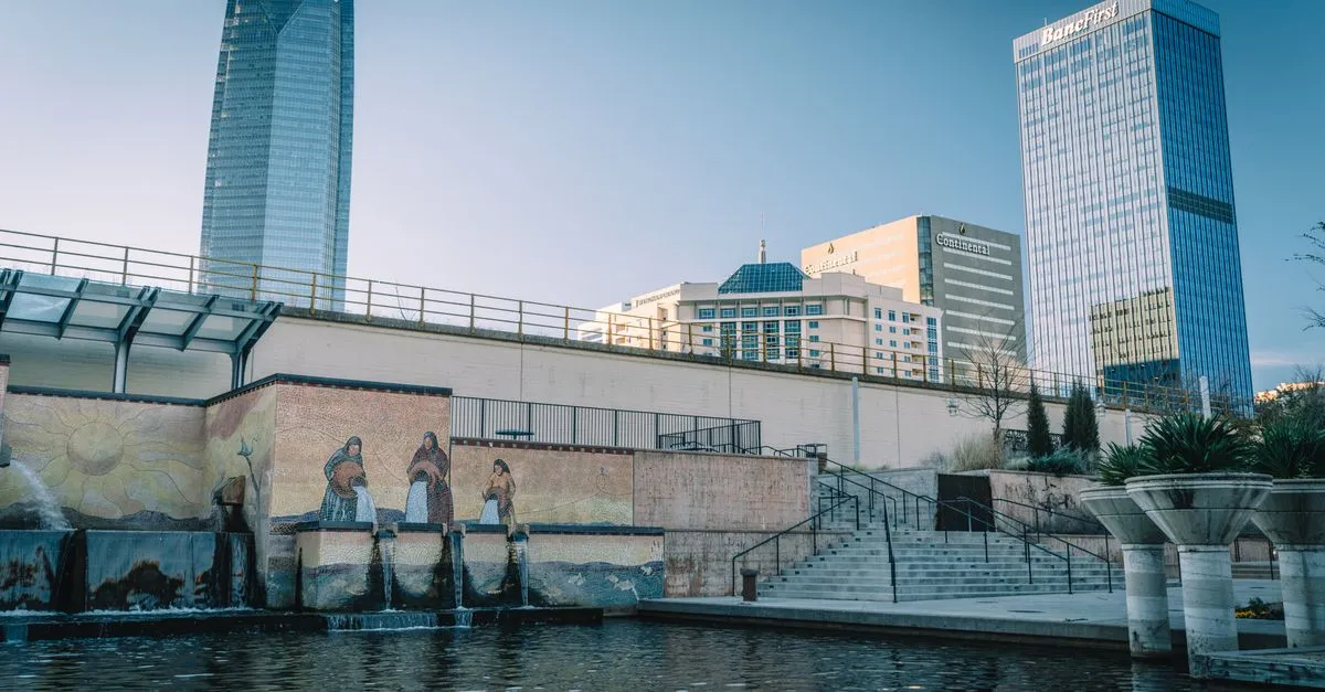 The Devon Energy Center, the Continental Resources building, and the BancFirst Tower rising over a mosaic water feature in downtown Oklahoma City.