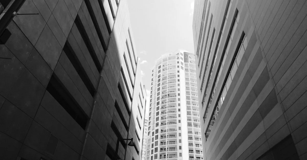Downtown Tampa high-rise towers shot in black and white from street level, the dense urban core a local business competes to be found in.