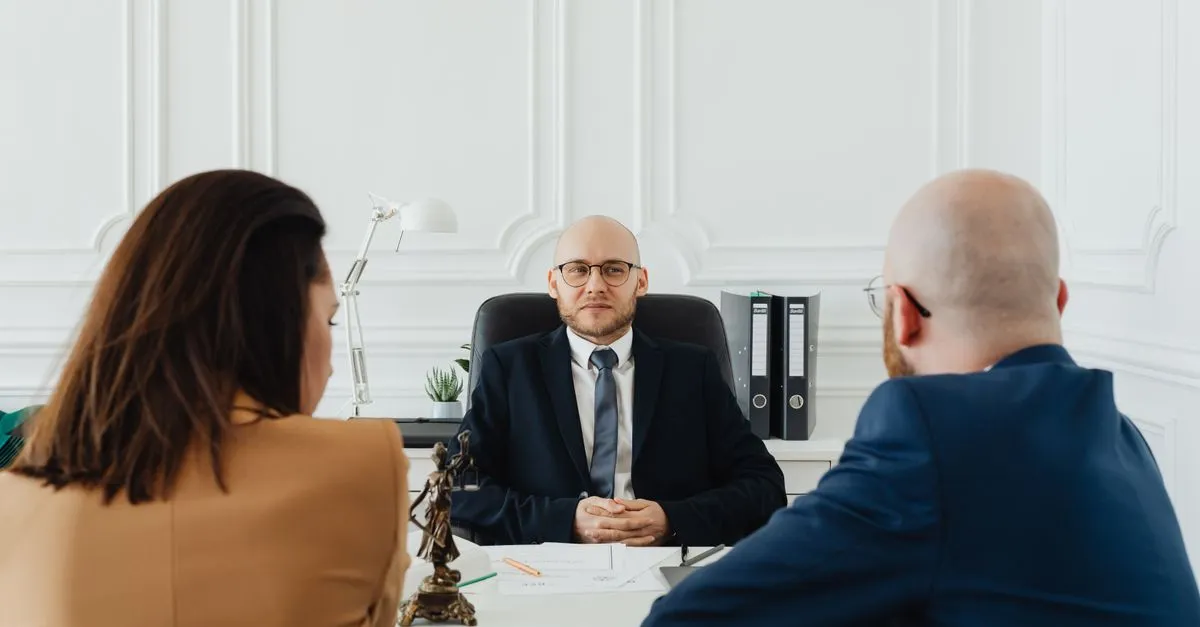 A defendant meeting a criminal defense lawyer to discuss charges during a private consultation.