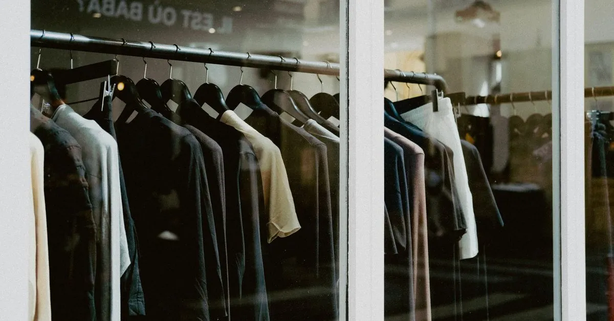 Clothing on hangers inside a fashion boutique window, the kind of apparel brand fashion SEO services helps get found.