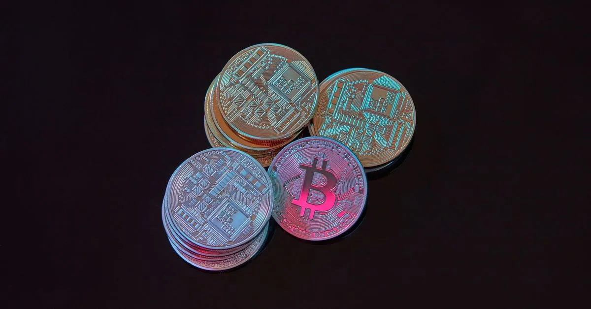 A stack of Bitcoin cryptocurrency coins on a black background, the kind of Web3 brand crypto SEO services helps get found in organic search.