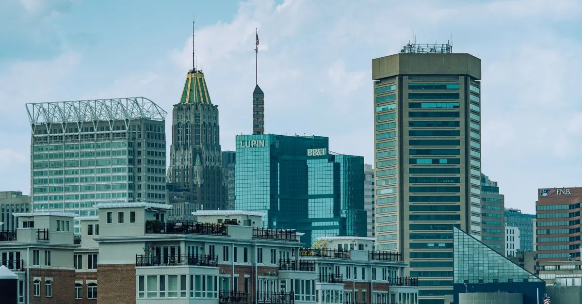 The Baltimore skyline of tall buildings rising over the city under a clear sky.