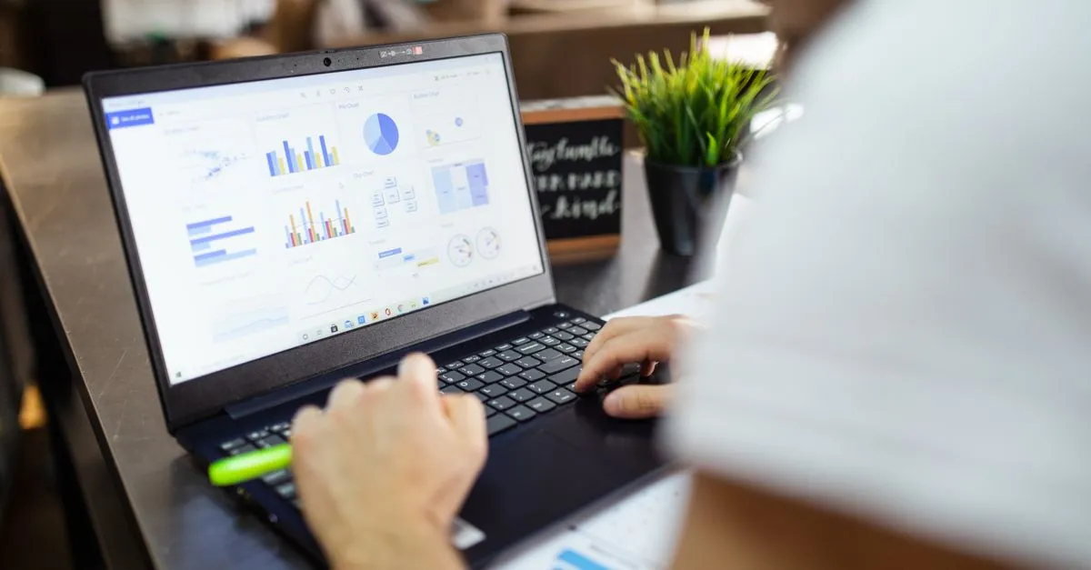 Focused analysis of charts and performance data on a laptop, the raw material of a content audit.