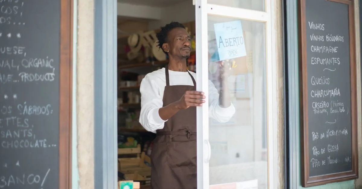 A shop owner flipping the sign to open, the real business behind every accurate listing.