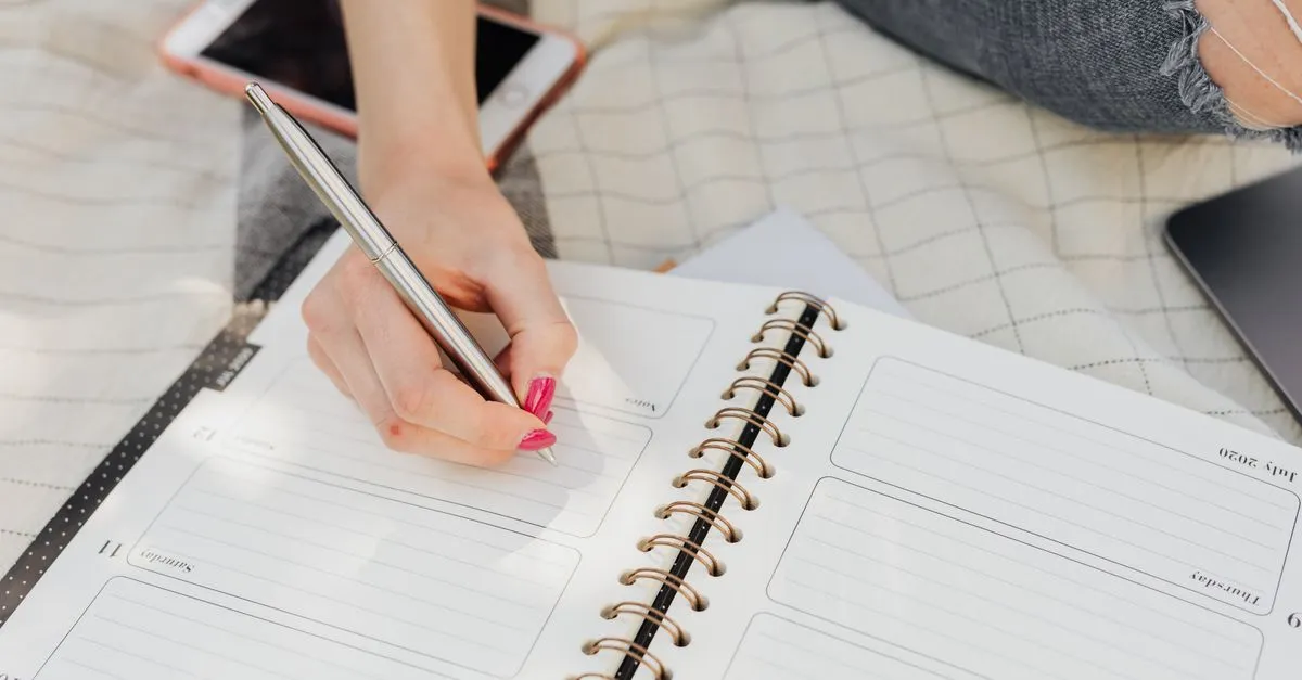 A person taking notes, mapping out the keywords customers actually search.
