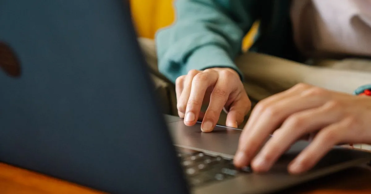 A business owner responding to a negative Google review on a laptop.