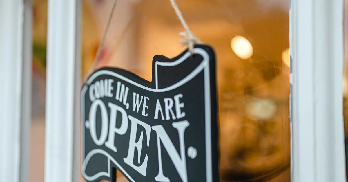 An open sign on a shop door, welcoming local customers.