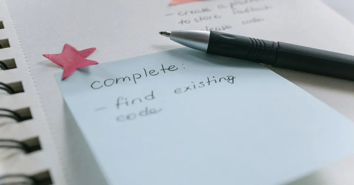 A handwritten to-do note on a sticky pad with a pen, showing short, scannable, structured content.