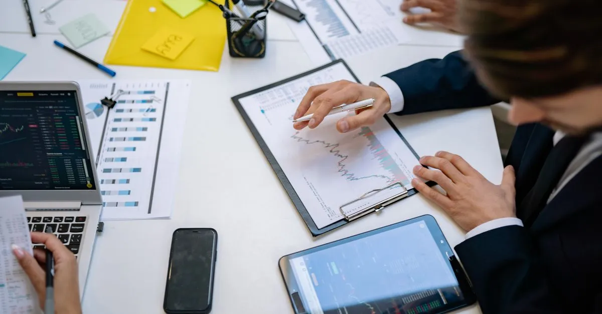 A team reviewing marketing analytics on tablets in an office.