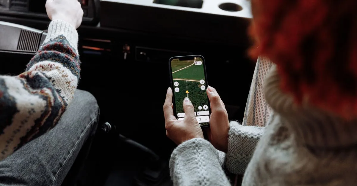 Two people using a navigation and maps app on a smartphone.